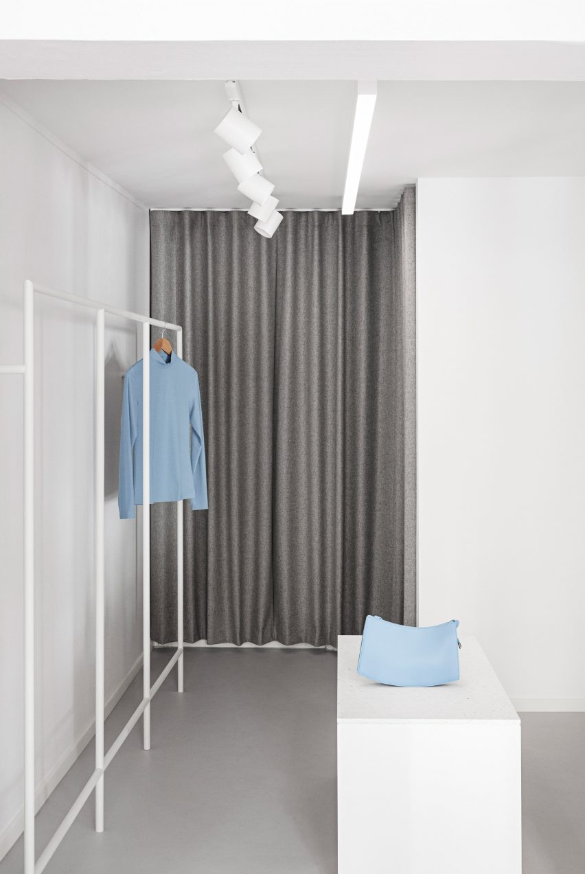 Grey wool changing room curtains and white rails in the OCE Copenhagen store interior