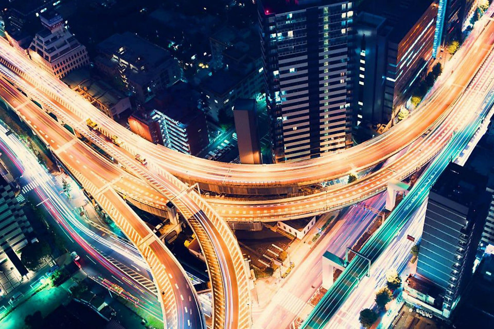Aerial view of a highway intersection at night in Shinjuku, Tokyo. (Credit: TierneyMJ/Shutterstock)