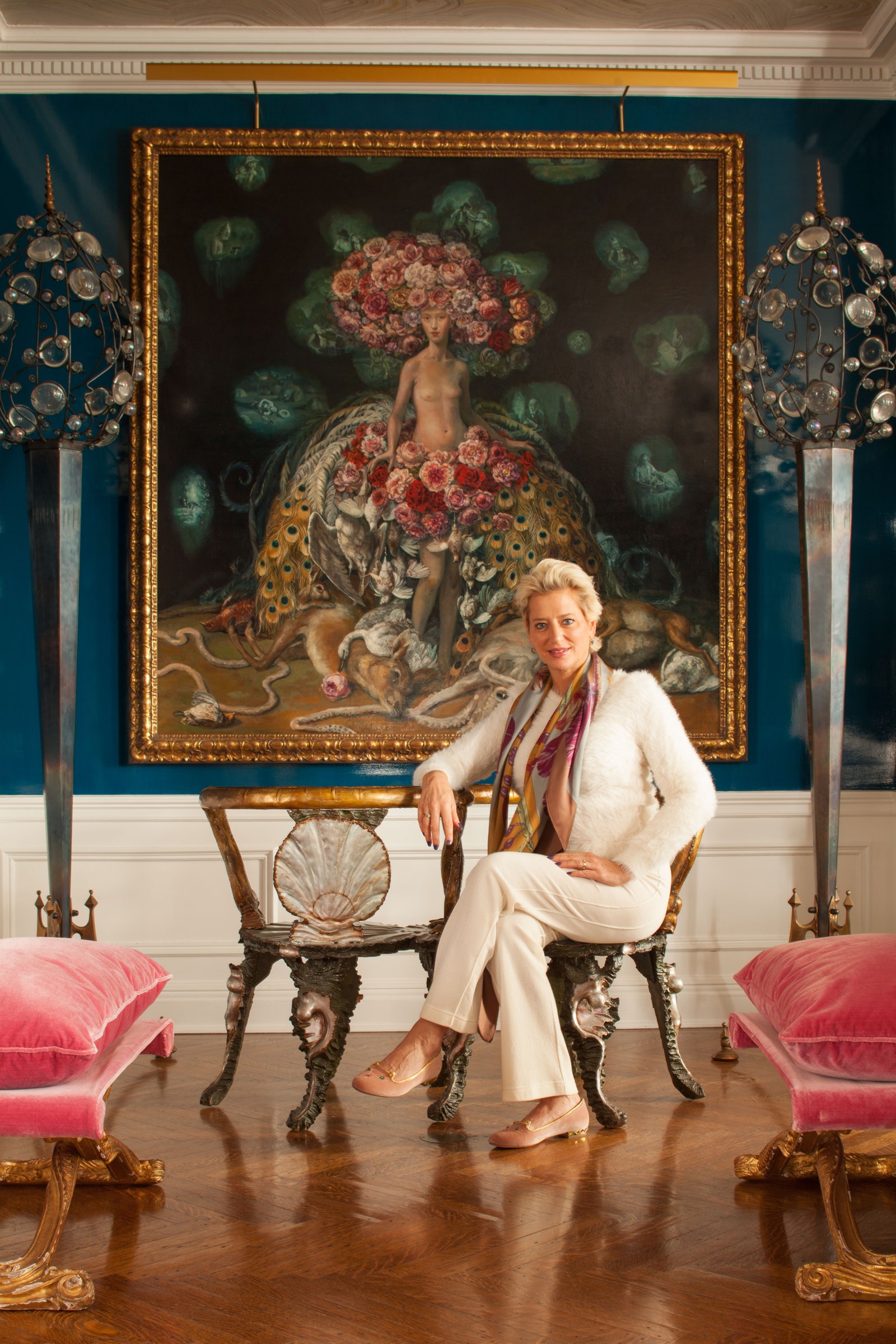a woman sitting on a bench in a grand room