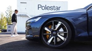 A close up of a Polestar vehicle in front of a company sign.