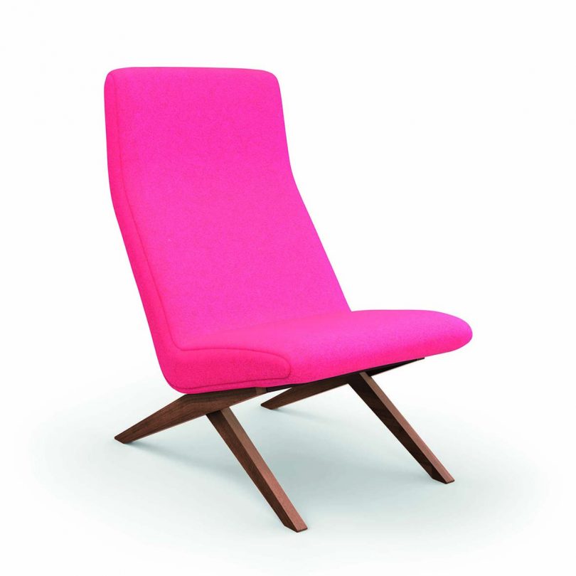 wood chair upholstered in bright pink on a white background