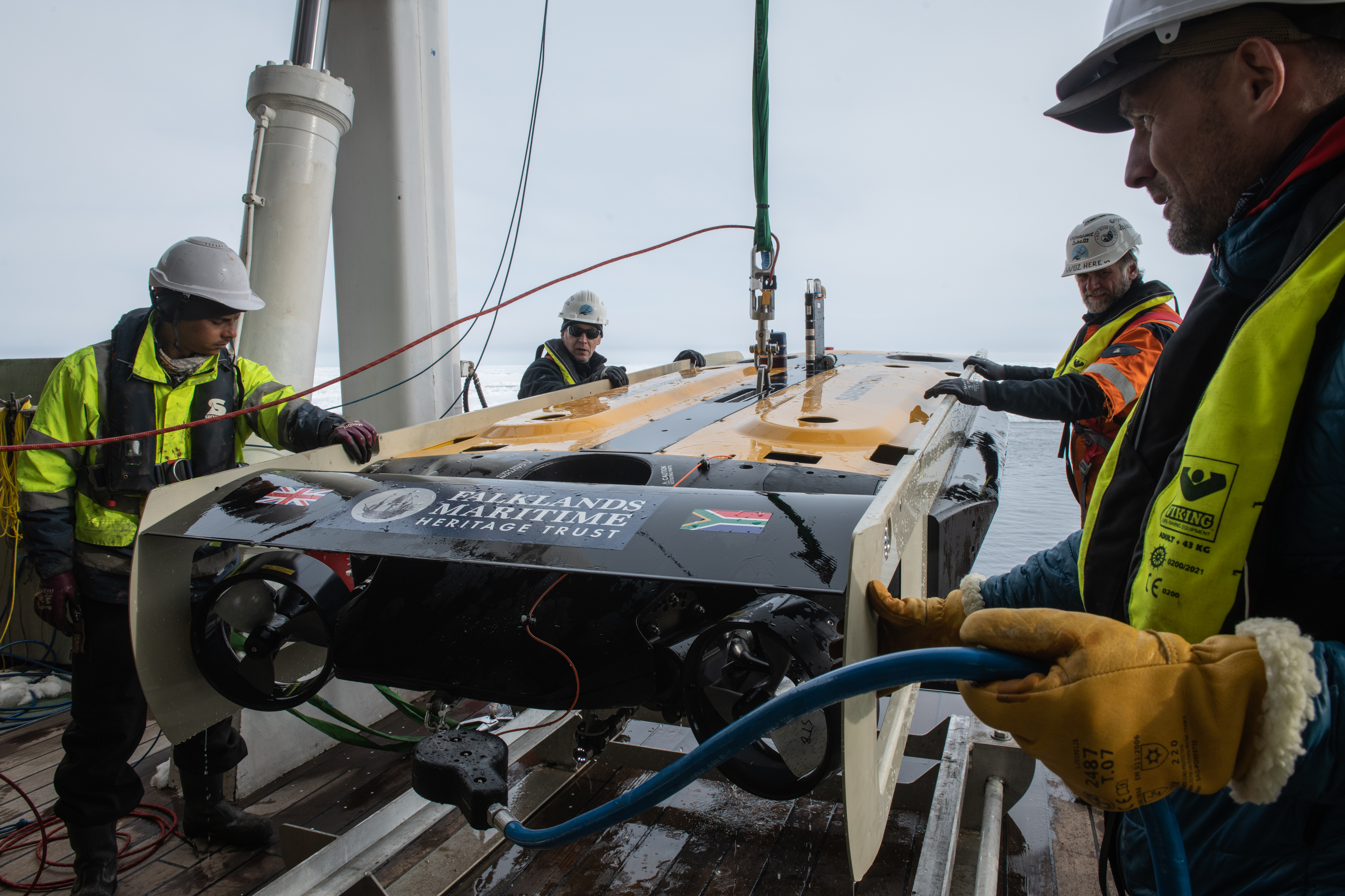 Sub-sea team of Endurance22 expedition and crew of S.A.Agulhas II recover the AUV after a dive in the Weddell Sea, in search for Sir Ernest Shacklaton's ship the Endurance. From left to right: Dean Cedras crew of S.A.Agulhas II, J.C. Caillens, Off-Shore Manager, Frédéric Bassemayousse and Wayne Auton from White Desert team. 